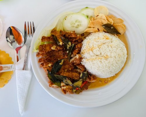 A simple plate of Indonesian traditional food with rice, vegetables, and tofu