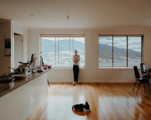 A relaxed person drinking water in a bright room